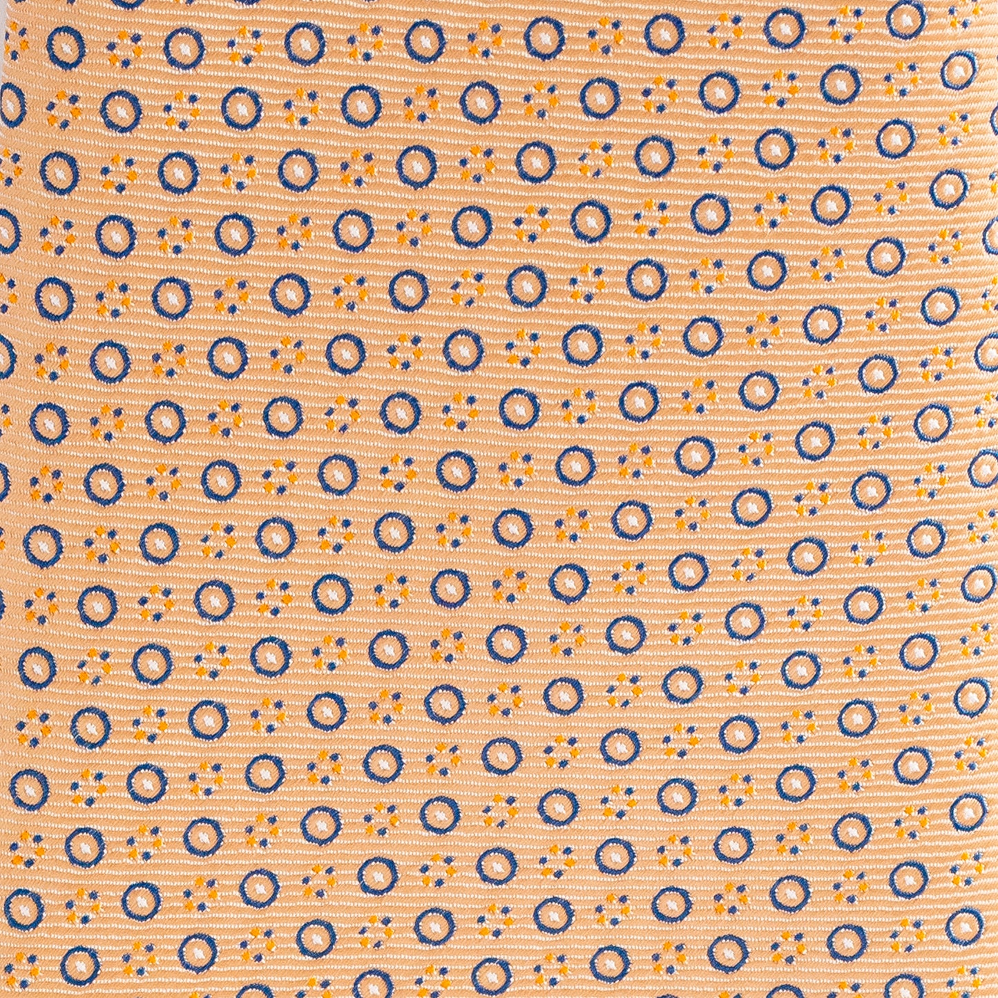 Patterned fabric with blue and orange circles on a peach background