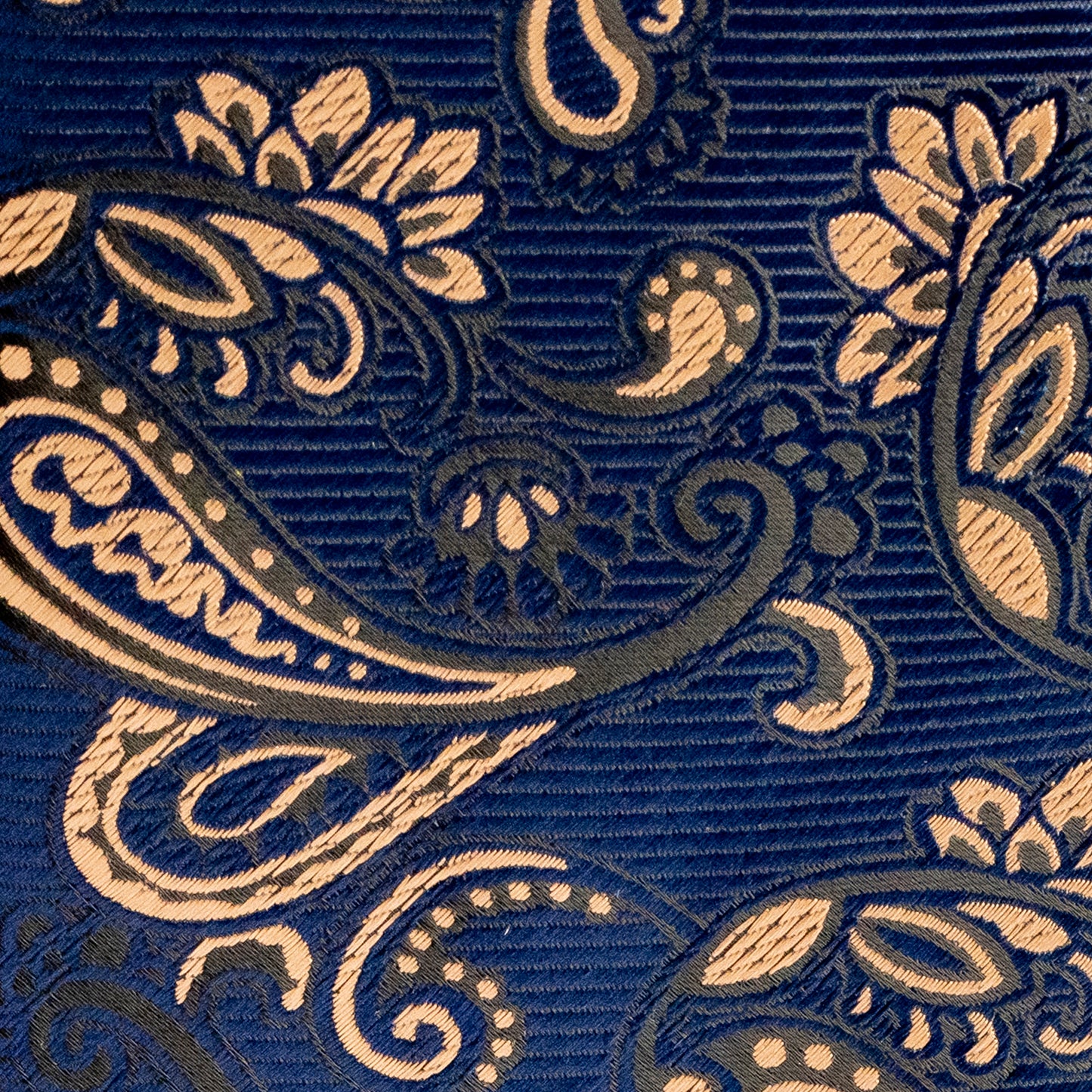 Close-up of a blue fabric with beige paisley pattern