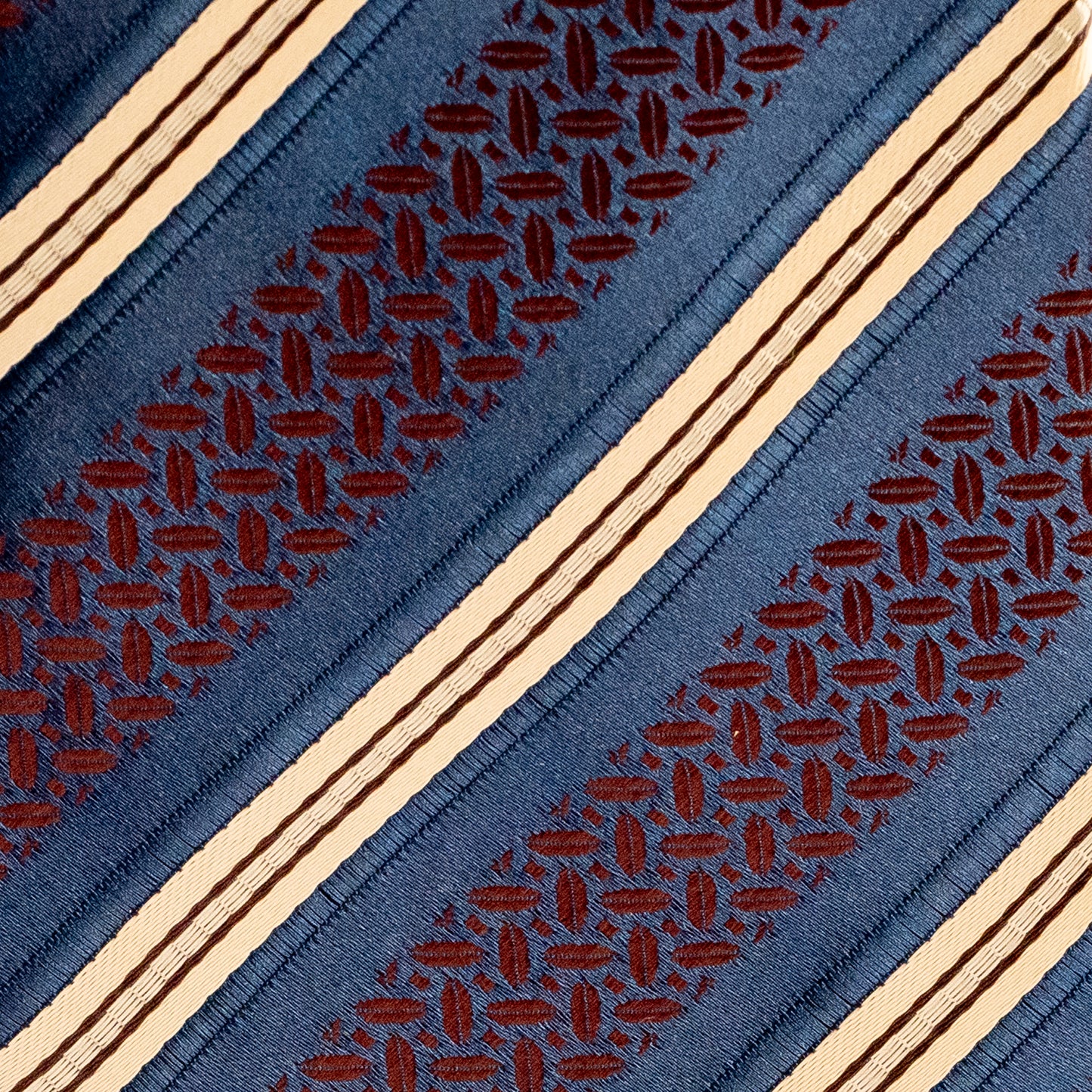 Close-up of a patterned fabric with blue background and brown geometric design
