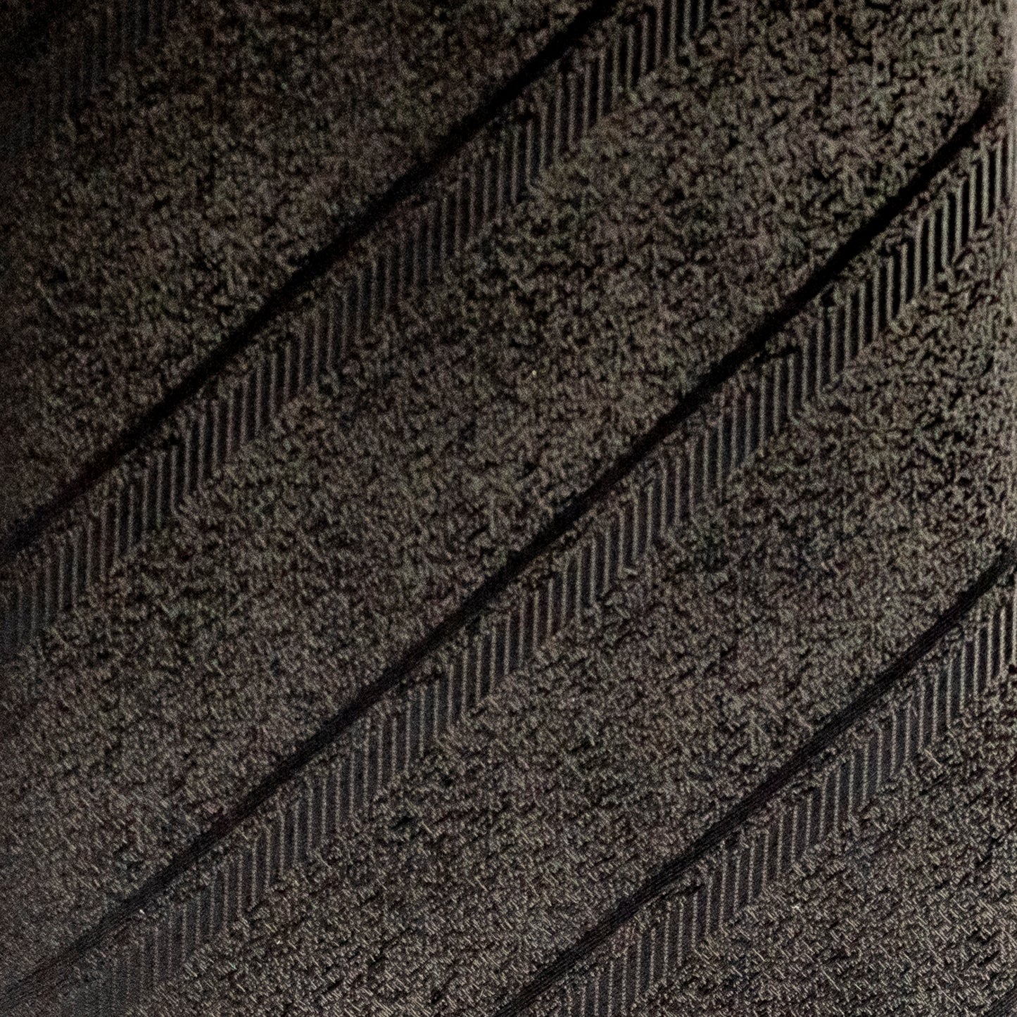 Close-up of a tire tread pattern on a dark background
