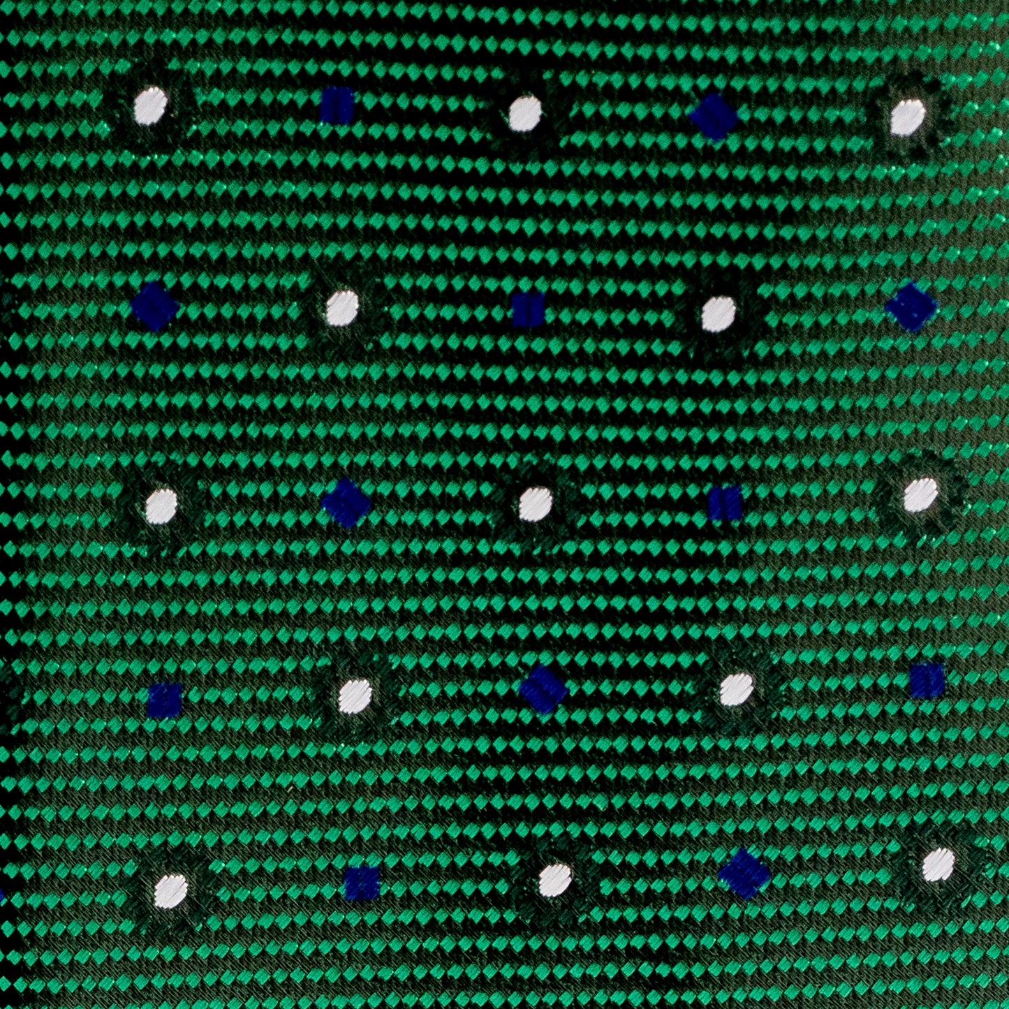 Close-up of a green fabric with blue and white dot pattern