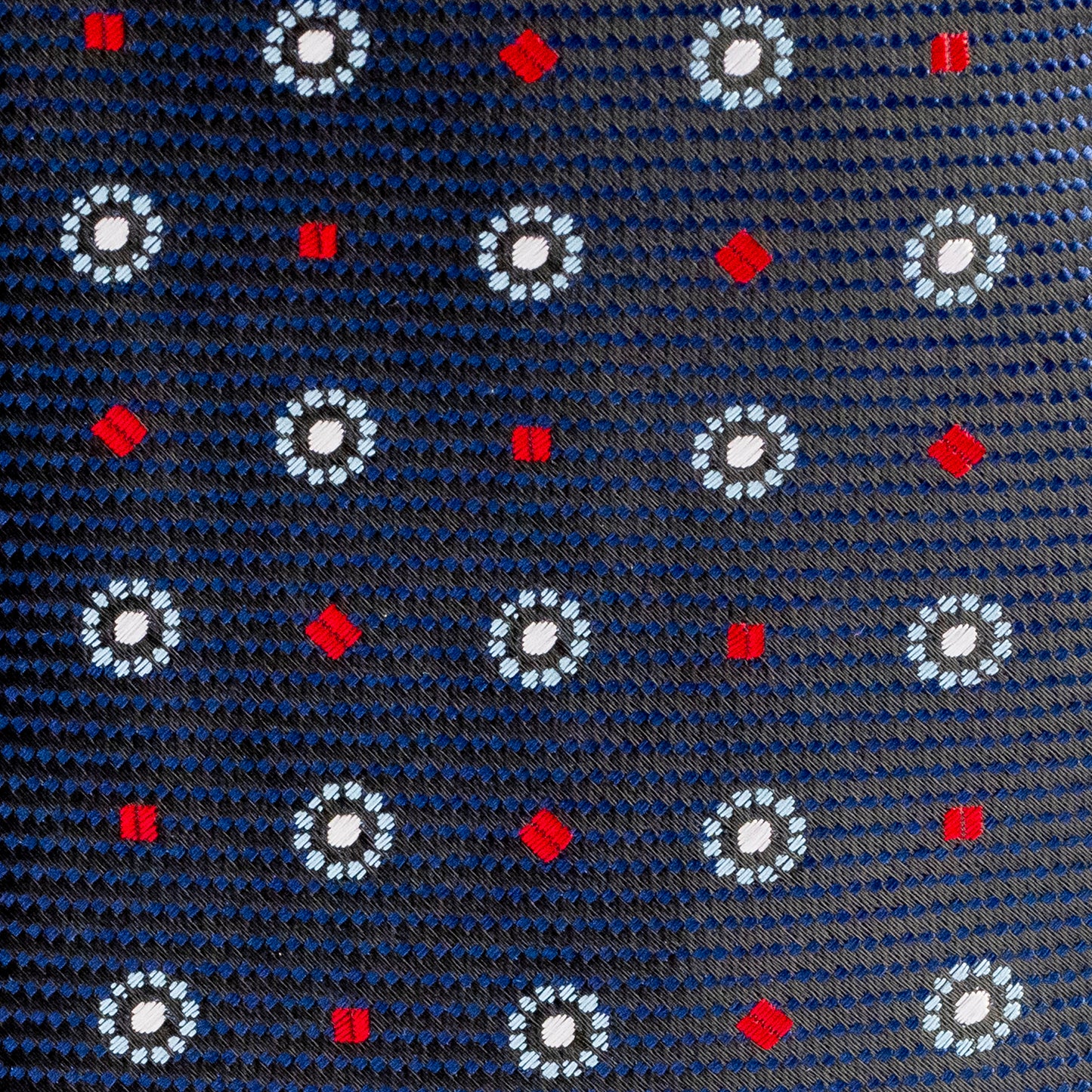 Navy blue tie with white floral patterns and red accents