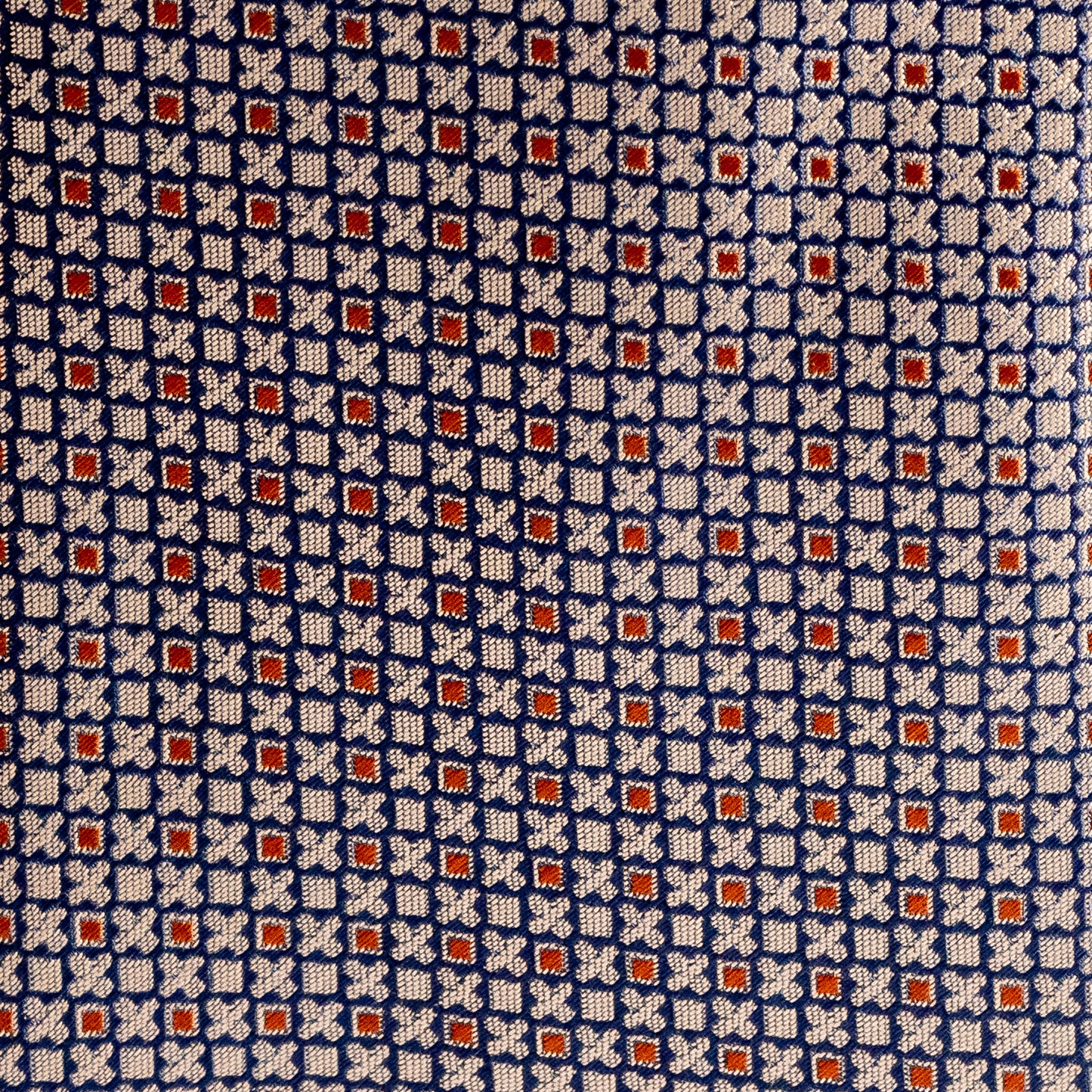 Patterned fabric with a blue, white, and red geometric design.