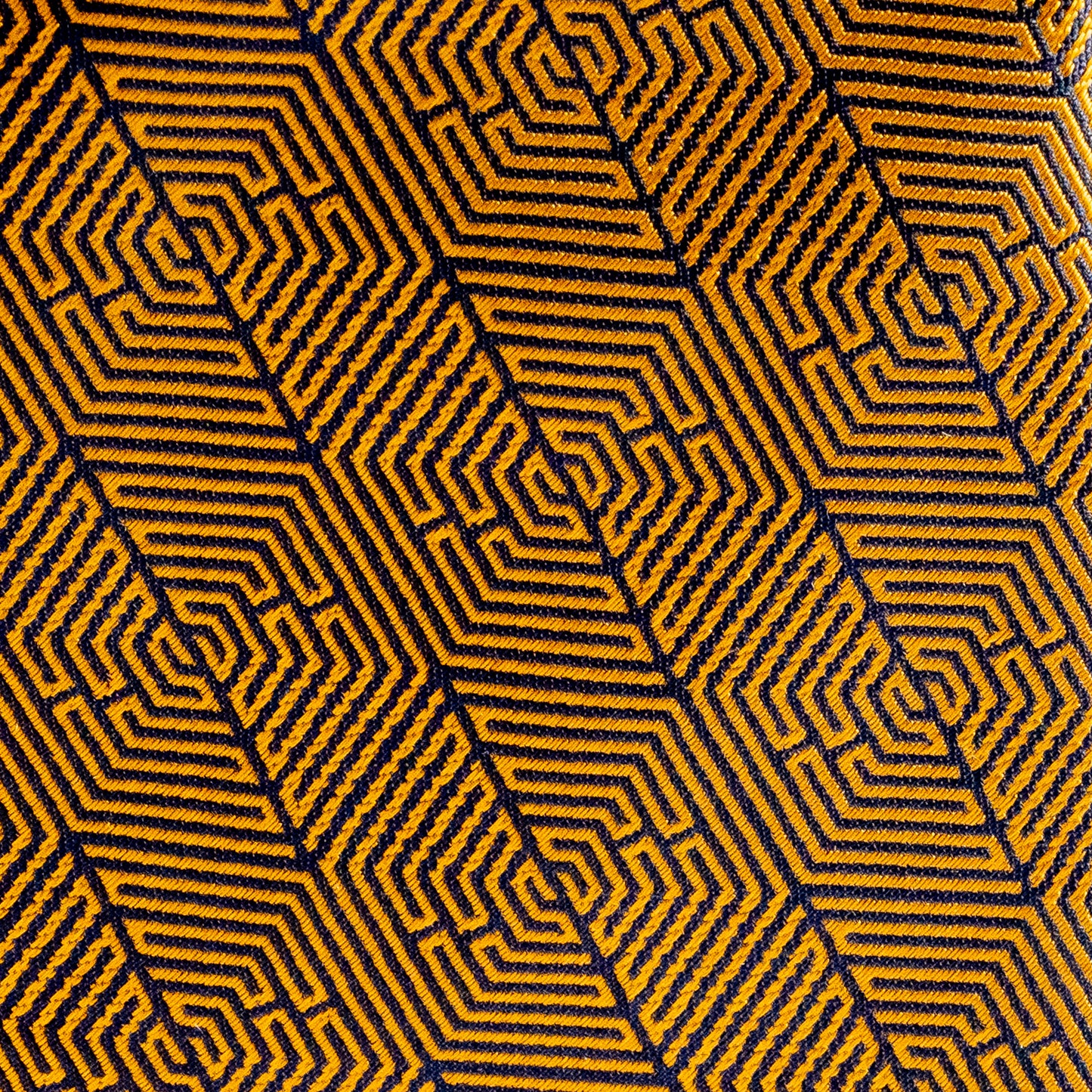 Hexagonal pattern with yellow and black lines on a textured fabric background