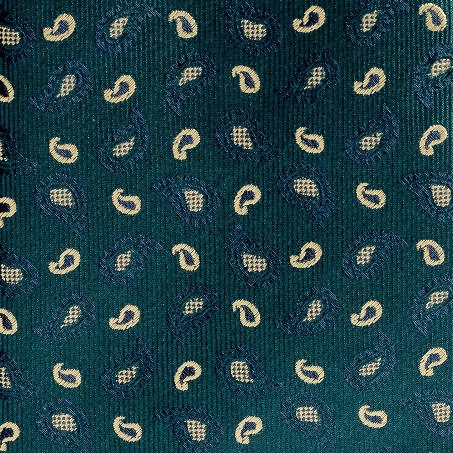 Close-up of a green tie with small white paisley patterns