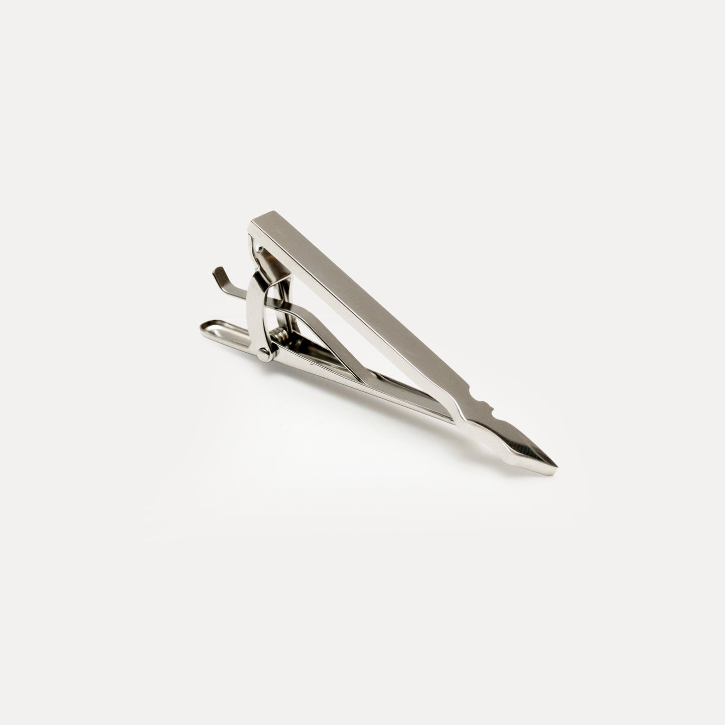 Metallic tie clip on a white background