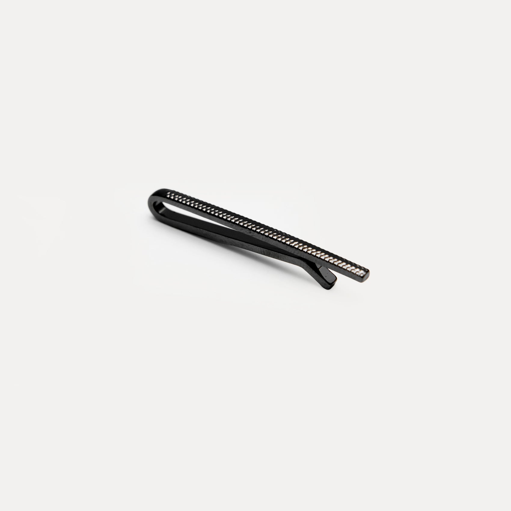 Metallic cylindrical component on a white background