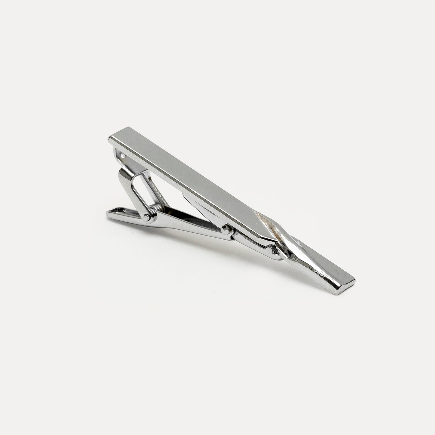 Silver tie clip on a white background