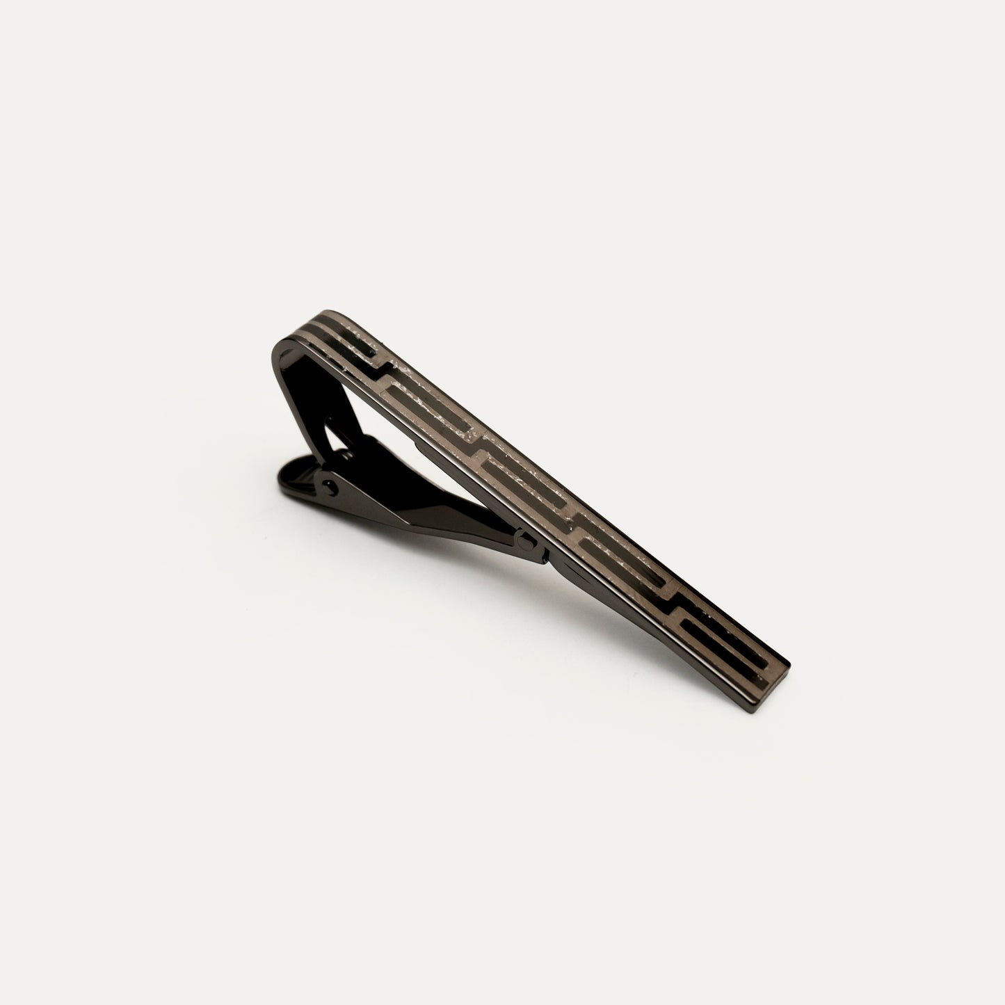 Black tie clip on a light gray background