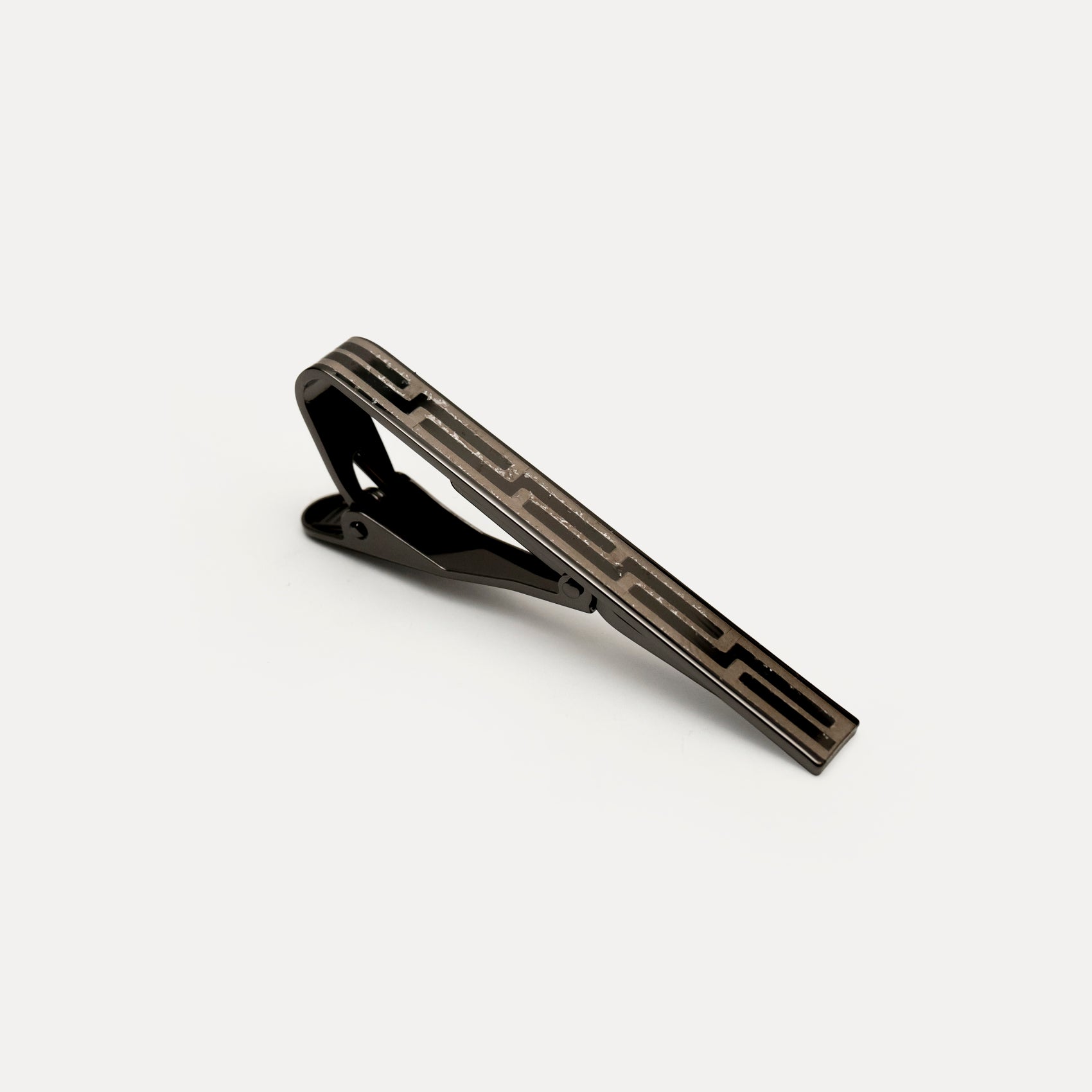 Black tie clip on a light gray background