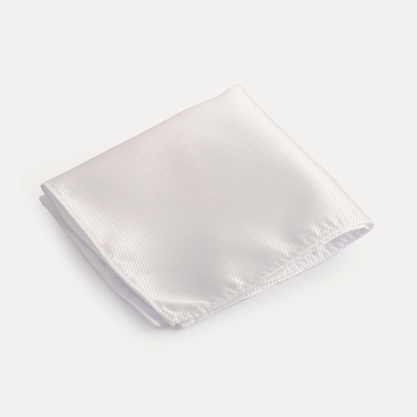 White textured pocket square on a light gray background