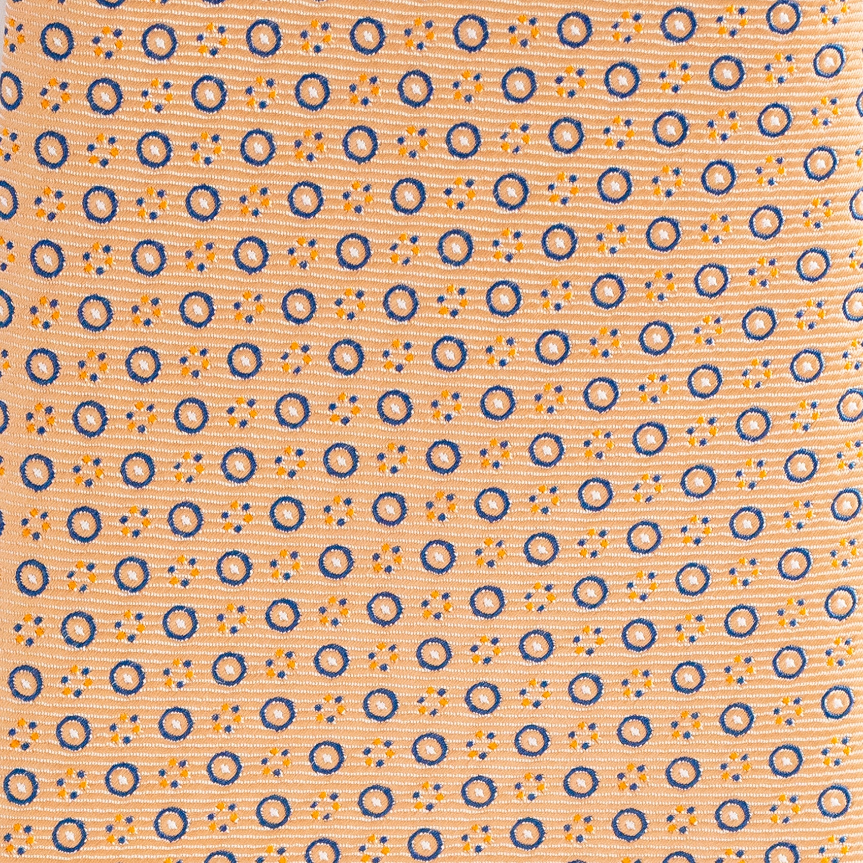 Patterned fabric with blue and orange circles on a peach background
