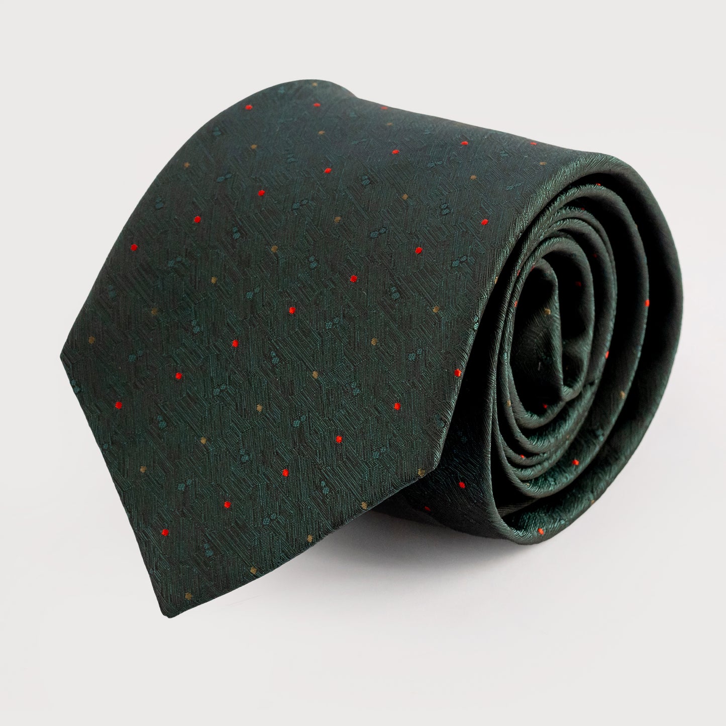 Rolled-up green tie with red polka dots on a light gray background