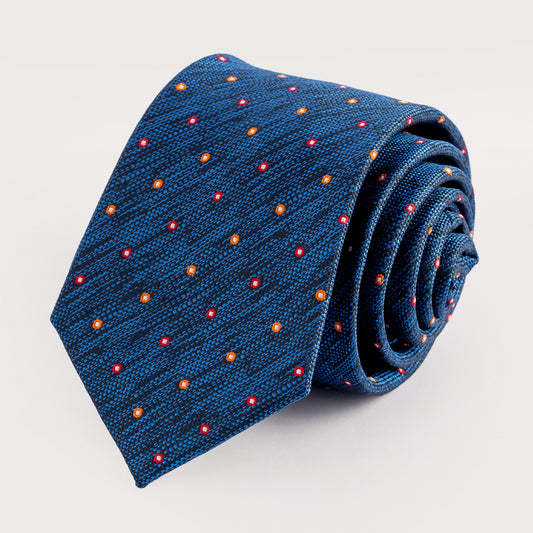 Rolled blue tie with red and orange dot pattern on a light gray background