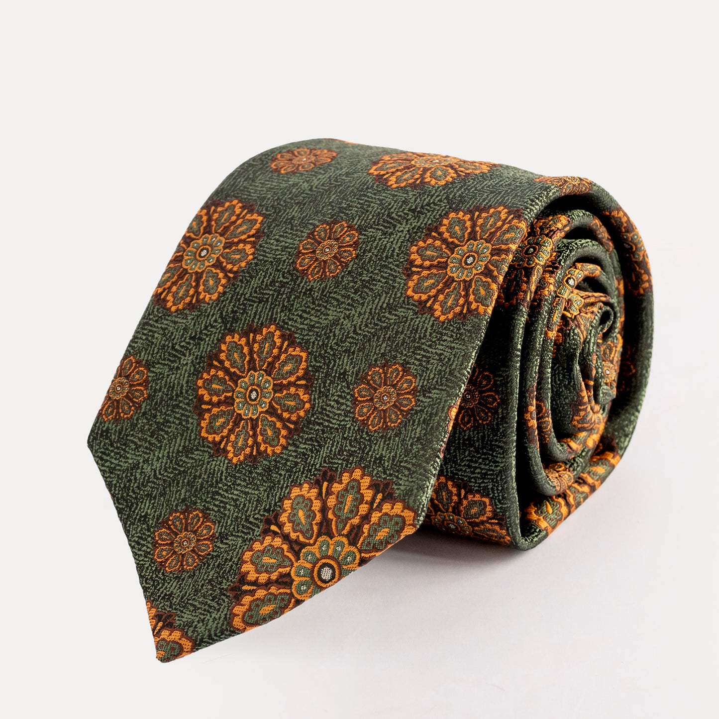 Green tie with brown floral pattern on a white background
