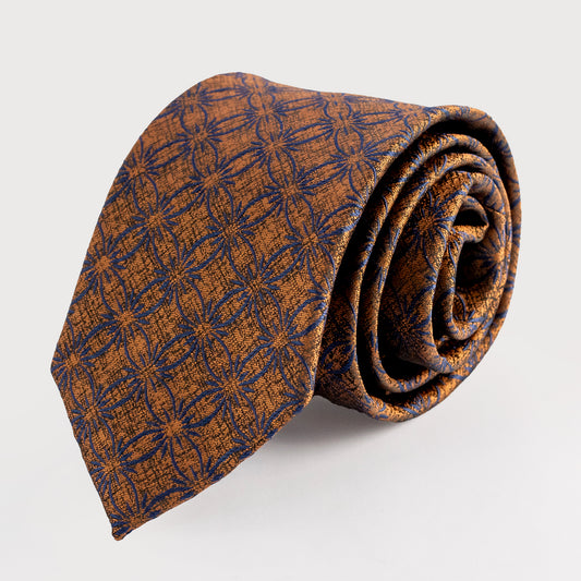 Rolled-up patterned tie on a light gray background