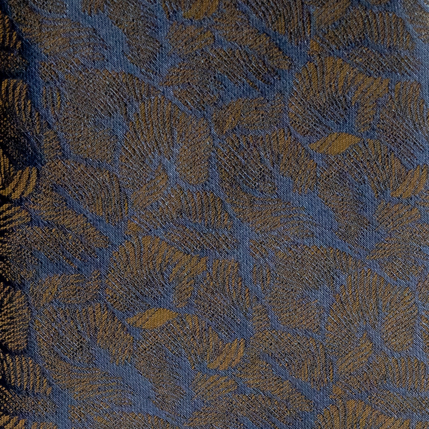 Textured fabric with leaf pattern in blue and green tones