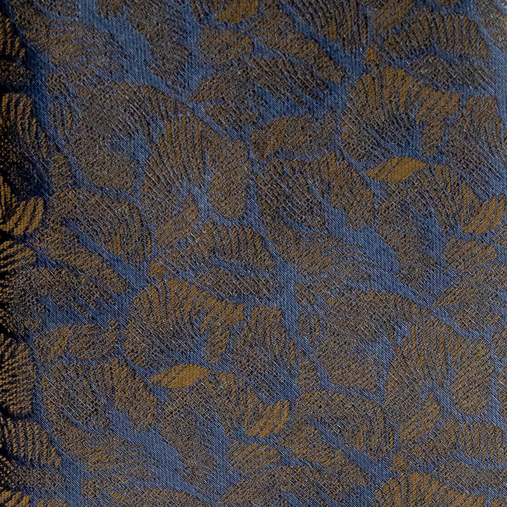 Textured fabric with leaf pattern in blue and green tones