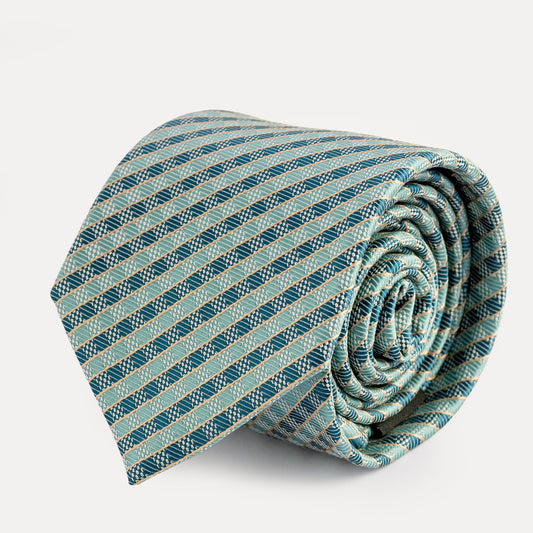 Rolled-up striped tie on a light gray background