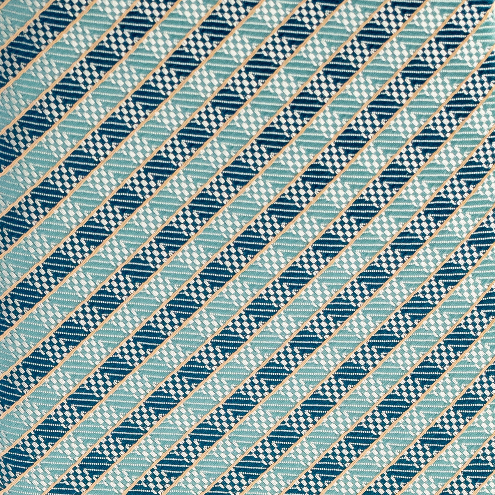 Diagonal striped pattern in blue and green on a textured fabric background