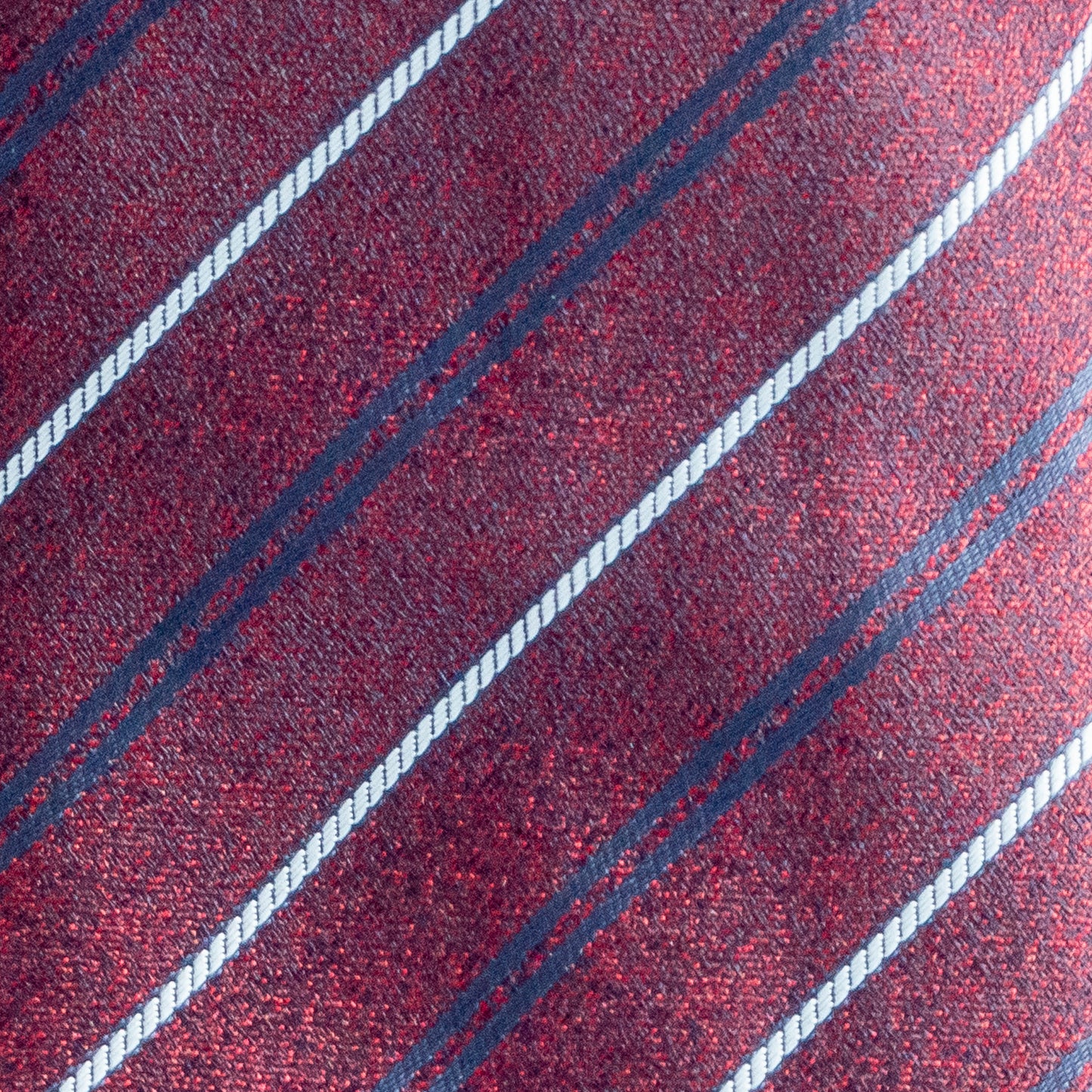 Close-up of a red fabric with blue and white diagonal stripes
