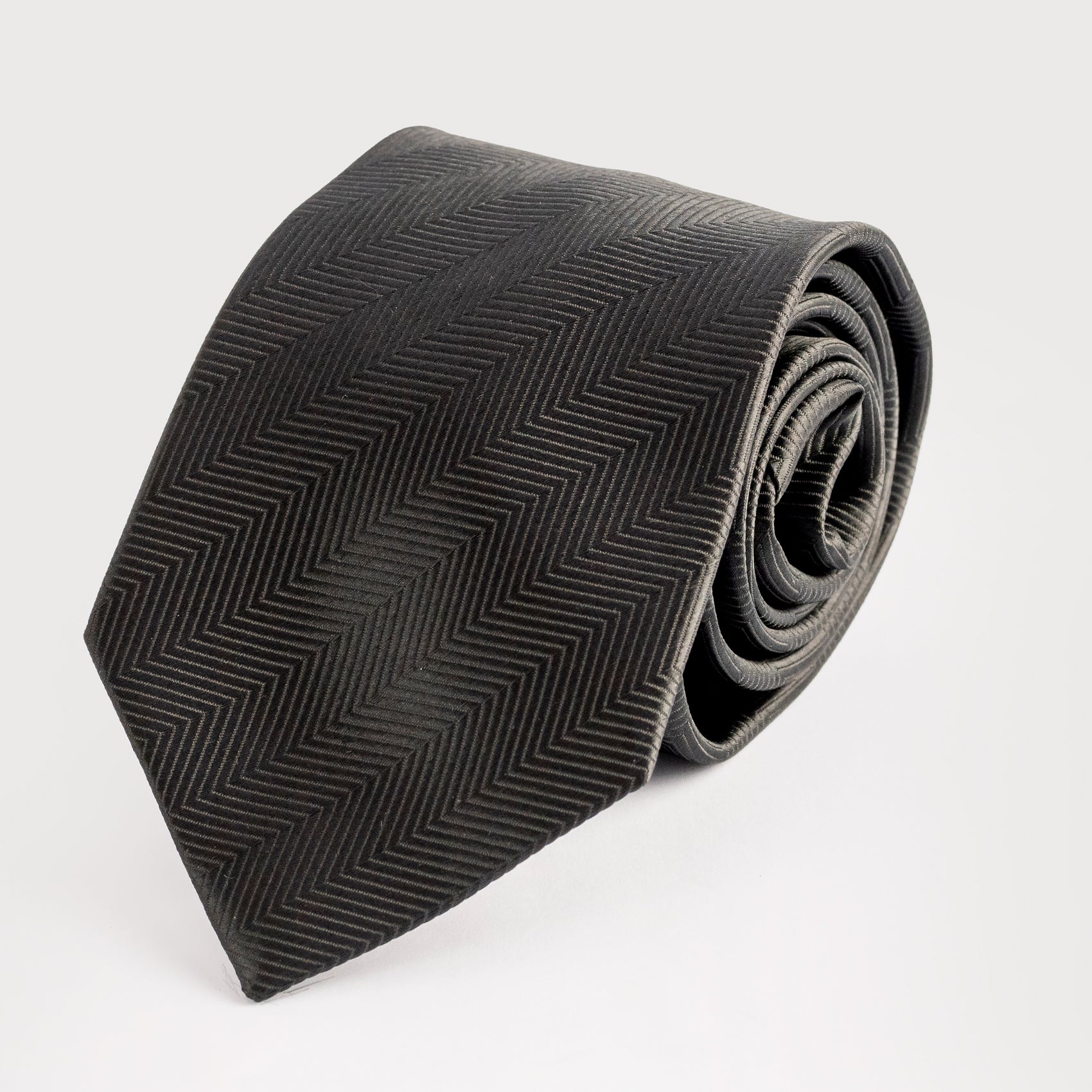 Black patterned tie on a light gray background