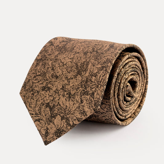 Roll of brown floral-patterned fabric on a white background