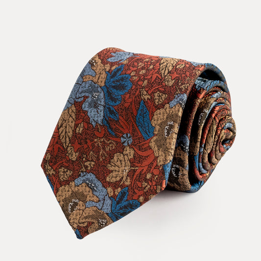 Roll of floral-patterned tie on a white background