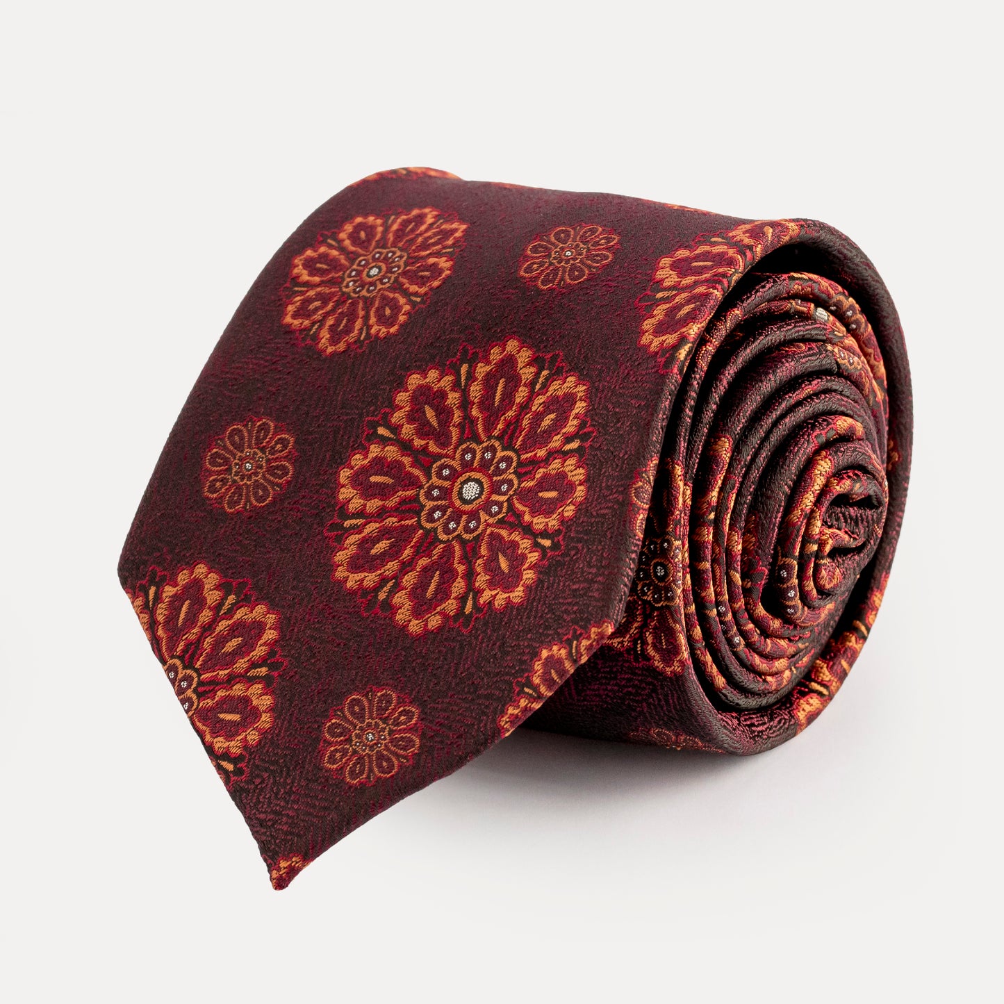 Roll of a patterned tie on a white background