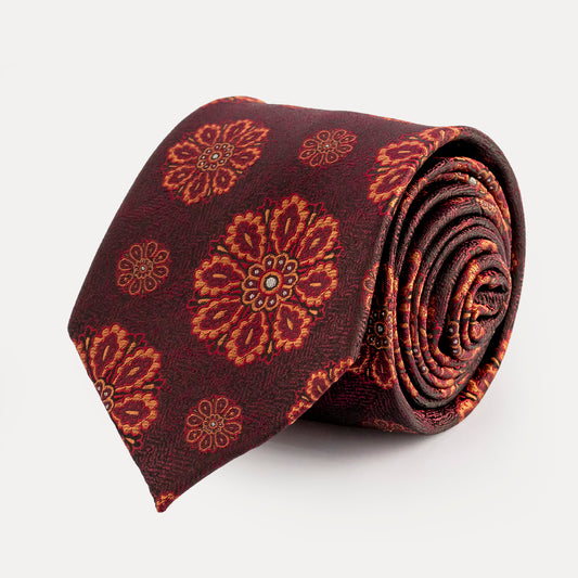 Roll of a patterned tie on a white background