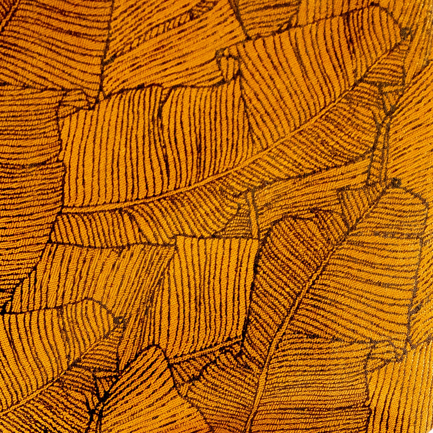 Close-up of a textured yellow fabric with leaf pattern