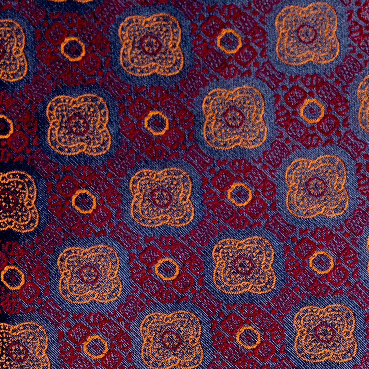 Patterned fabric with blue, red, and gold colors