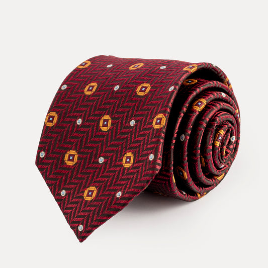 Rolled-up red tie with geometric pattern on a white background