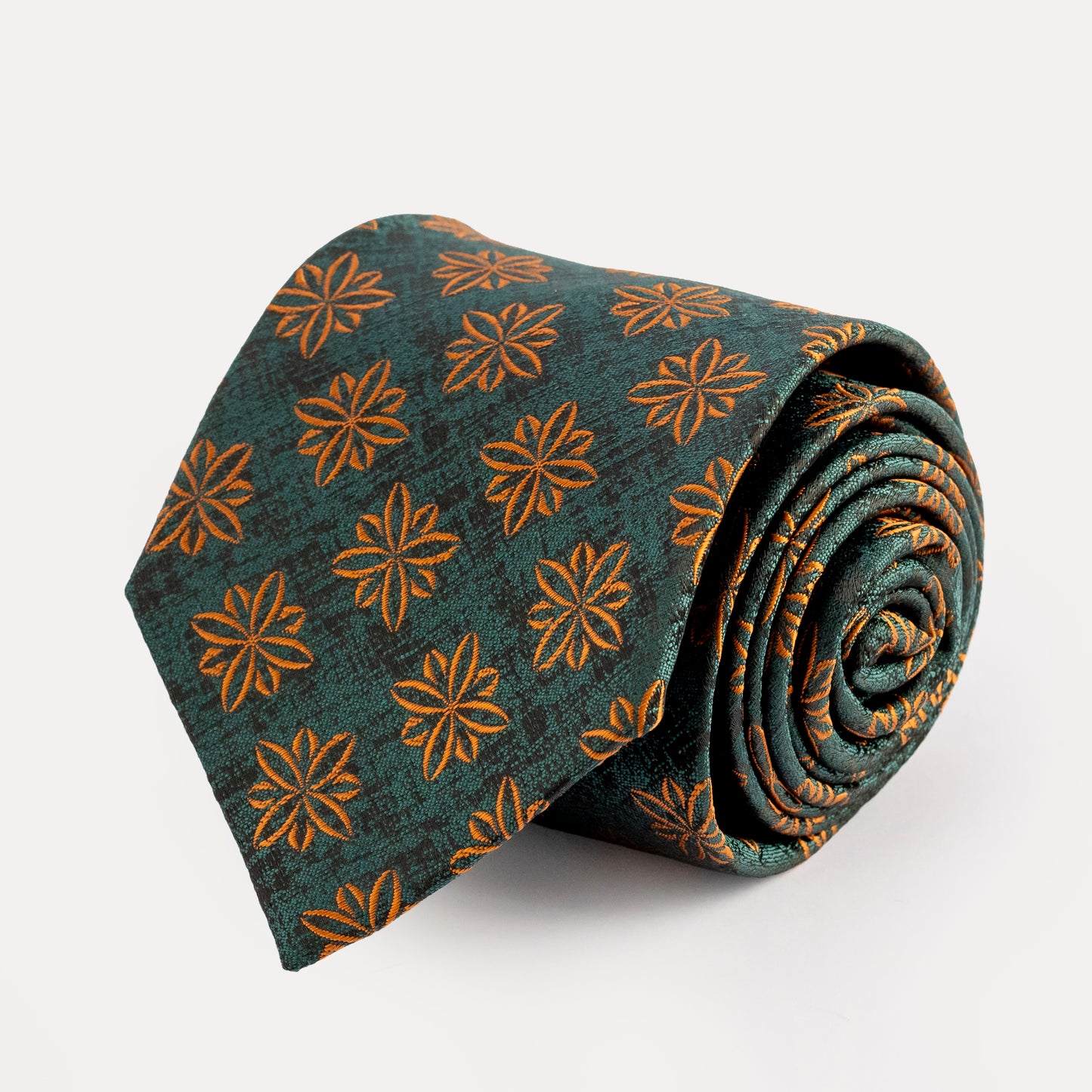 Rolled-up patterned tie with orange flowers on a teal background