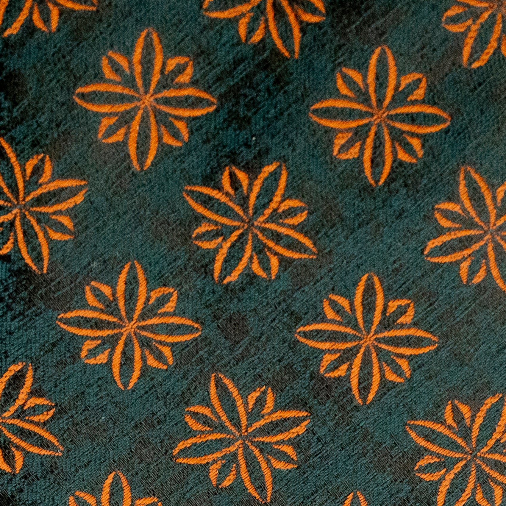 Pattern of orange flowers on a textured dark blue background
