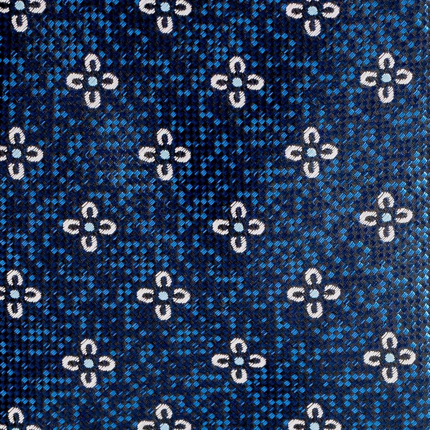 Close-up of a blue fabric with white floral pattern
