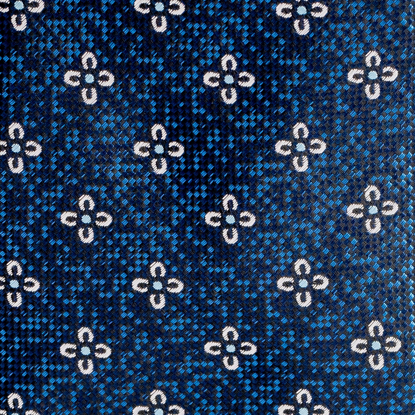 Close-up of a blue fabric with white floral pattern