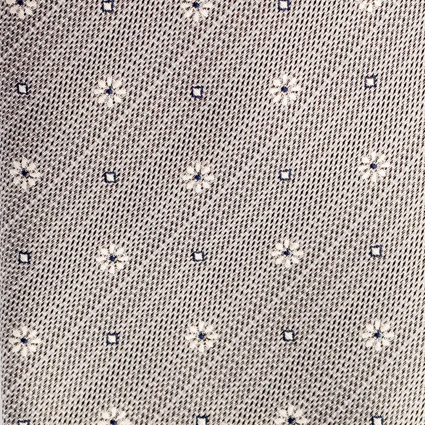 Close-up of a textured fabric with small floral patterns
