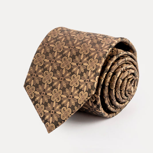 Roll of brown floral patterned tie on a white background