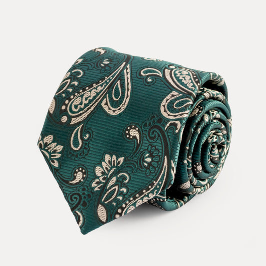 Rolled-up green paisley tie on a light gray background