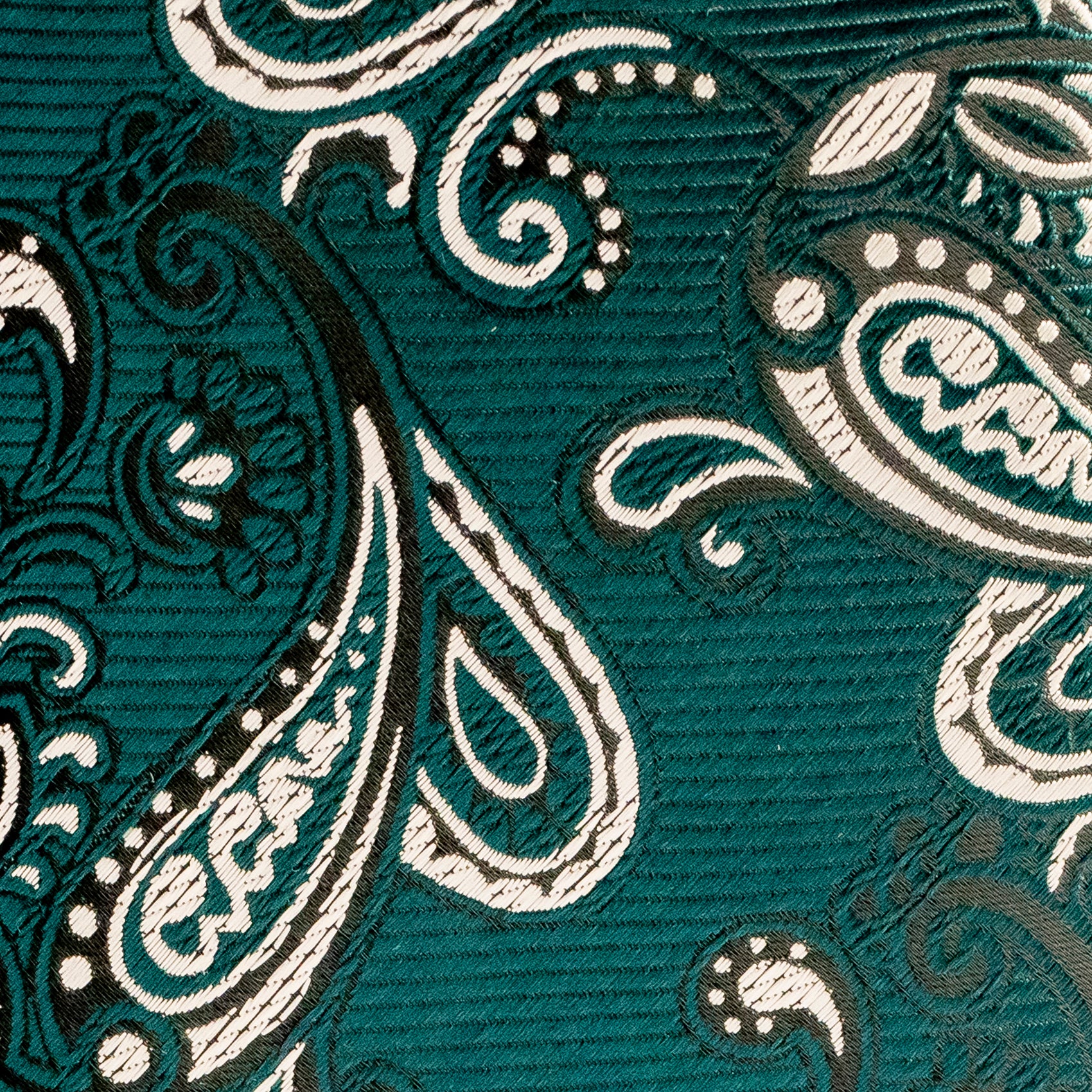 Close-up of a teal fabric with white paisley pattern