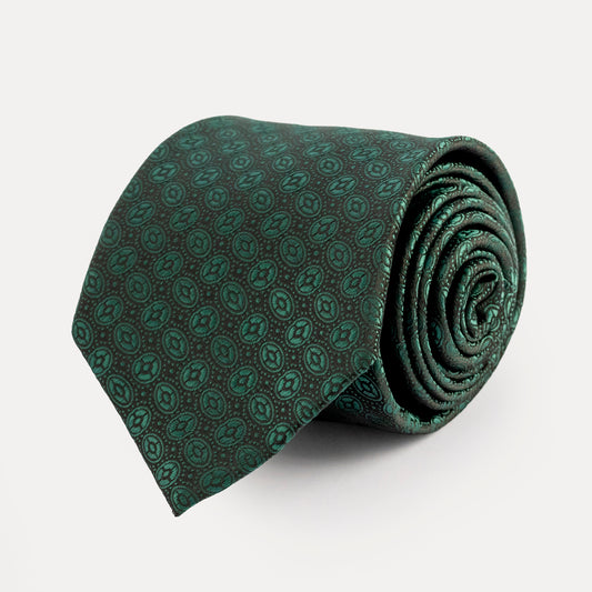 Rolled green patterned tie on a white background