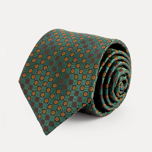 Rolled-up patterned tie on a light gray background