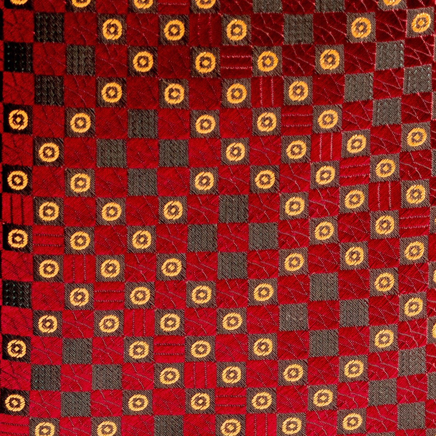 Patterned fabric with red, brown, and gold squares
