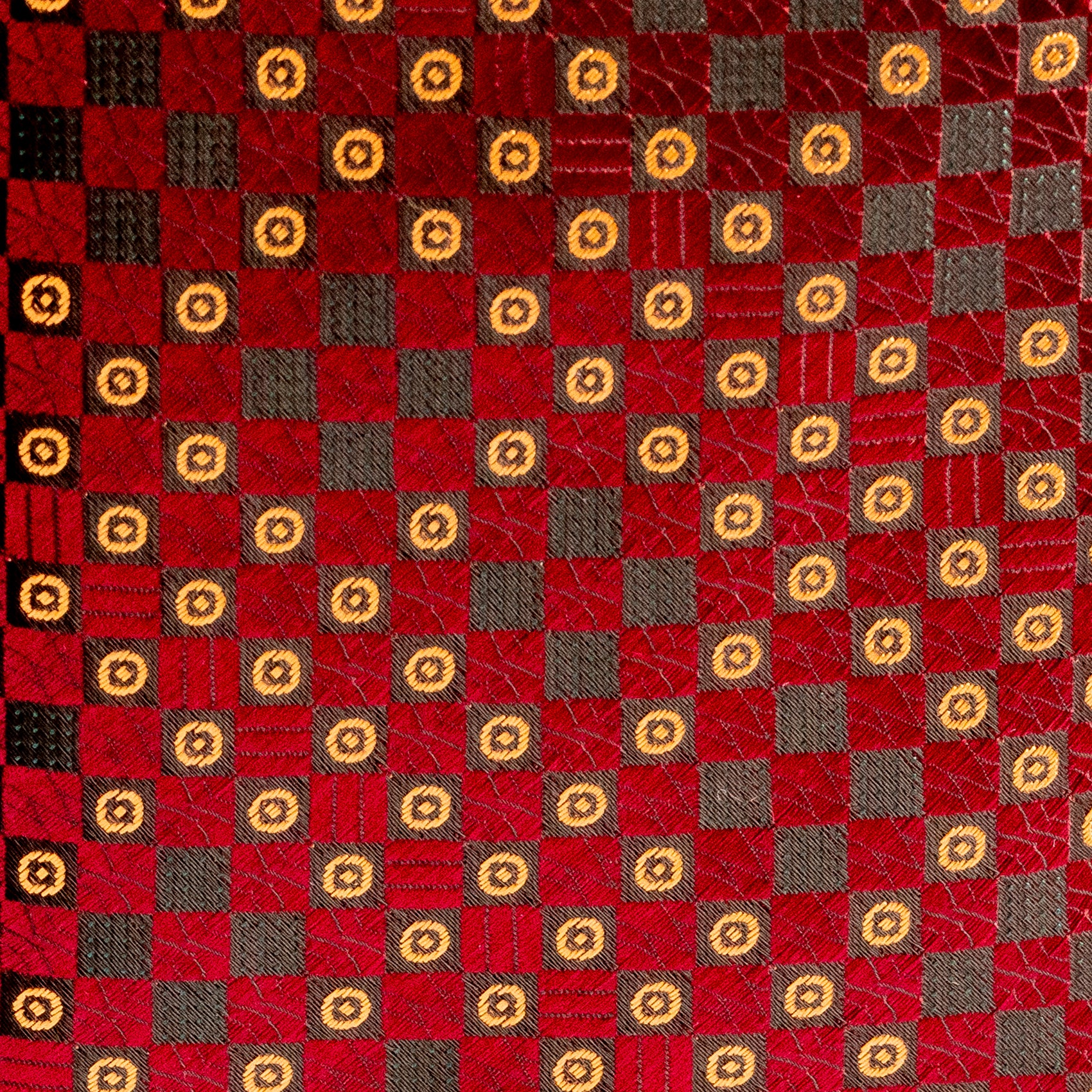 Patterned fabric with red, brown, and gold squares