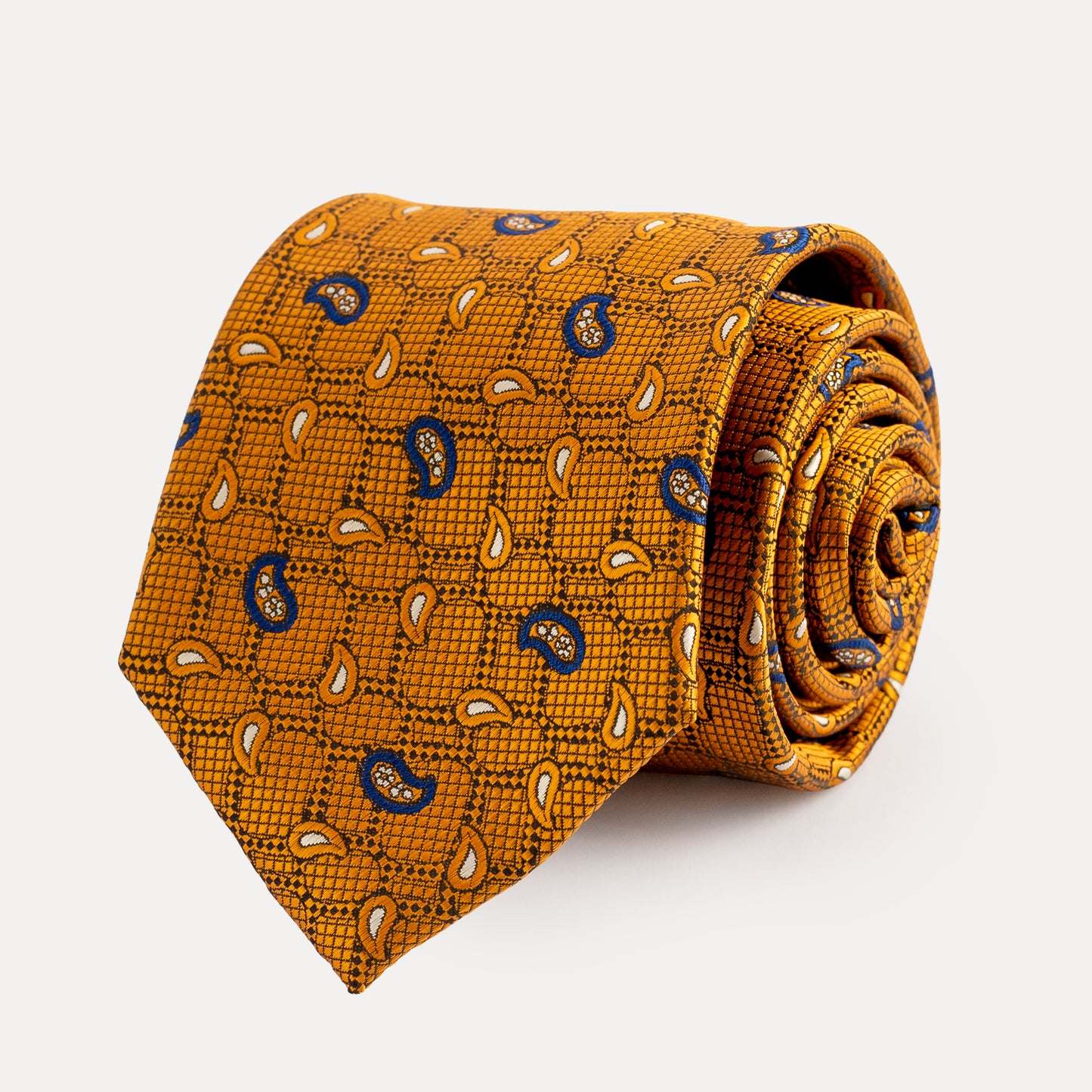 Rolled mustard yellow tie with pattern on a white background