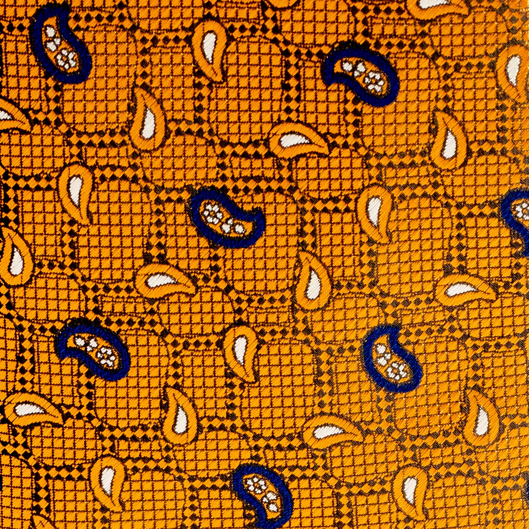Close-up of a patterned fabric with blue and orange design on a yellow background