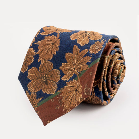 Floral patterned tie in brown and blue on a white background
