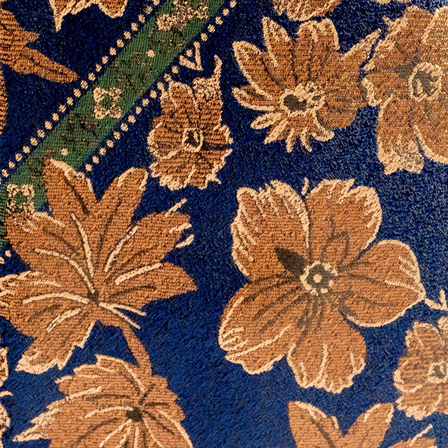 Close-up of a floral patterned fabric with brown flowers on a blue background