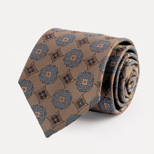 Rolled-up patterned tie on a white background